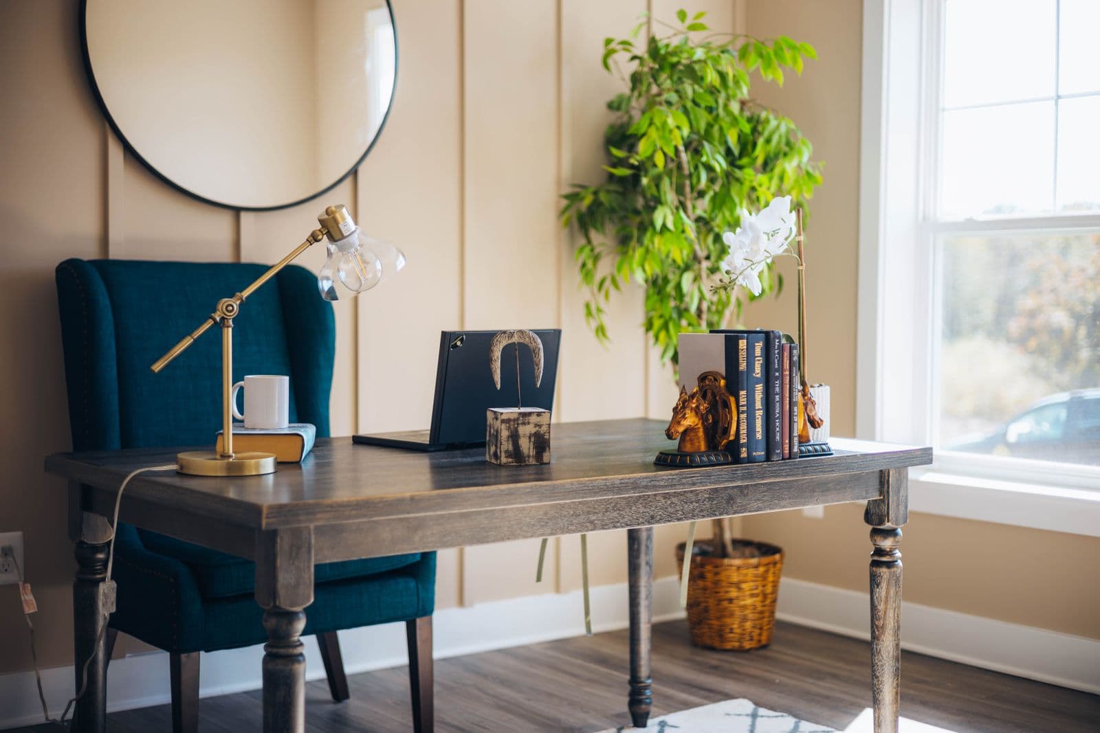 Premium executive office desk with a laptop, plants, and books